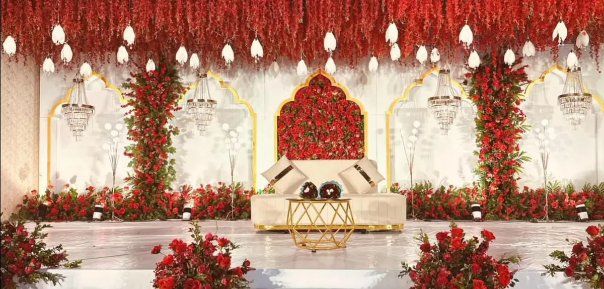 Red rose stage with gold arches and crystal chandeliers — Shadhi Catering and Event Management