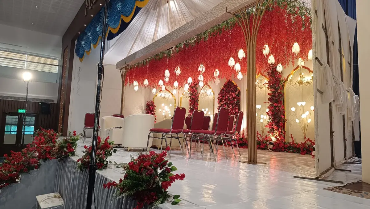 Red floral stage set for the guests — Shadhi Catering and Event Management